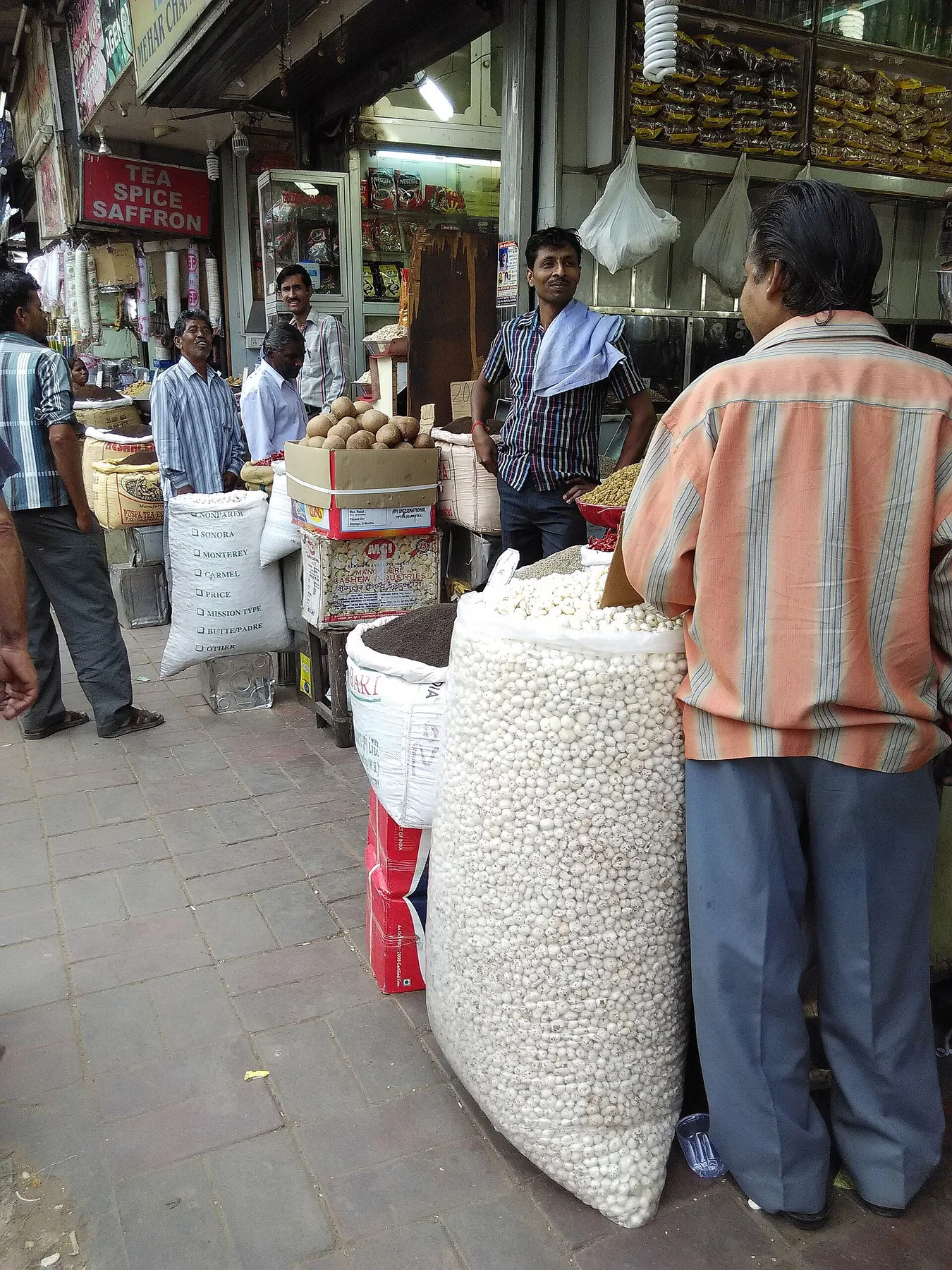 Dry fruit traders and sacks of produce in Khari Baoli market